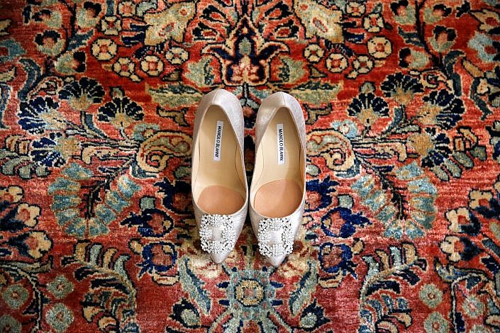 Manolo Blahnik wedding shoes on an oriental rug