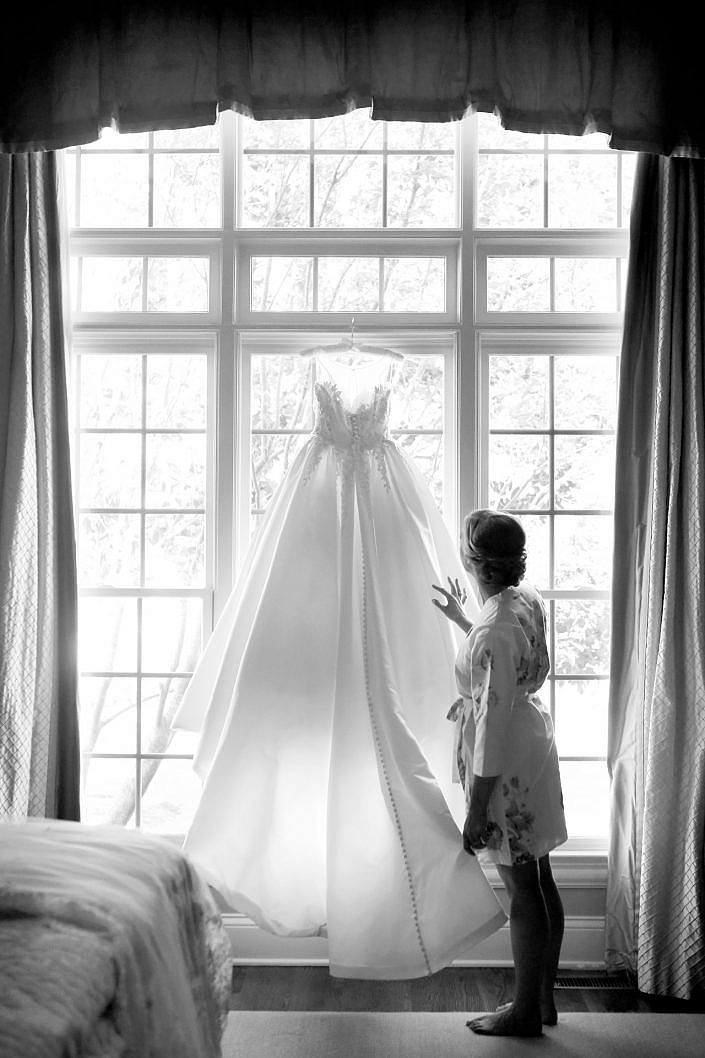 bride admires her wedding gown