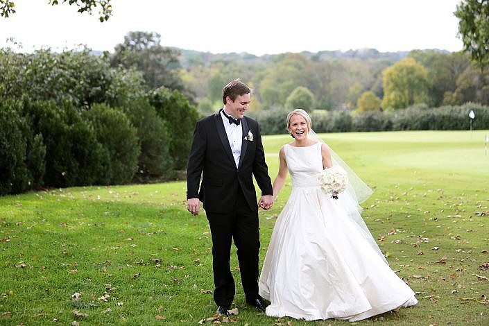bride and groom walk on the golf course at belle meade country club